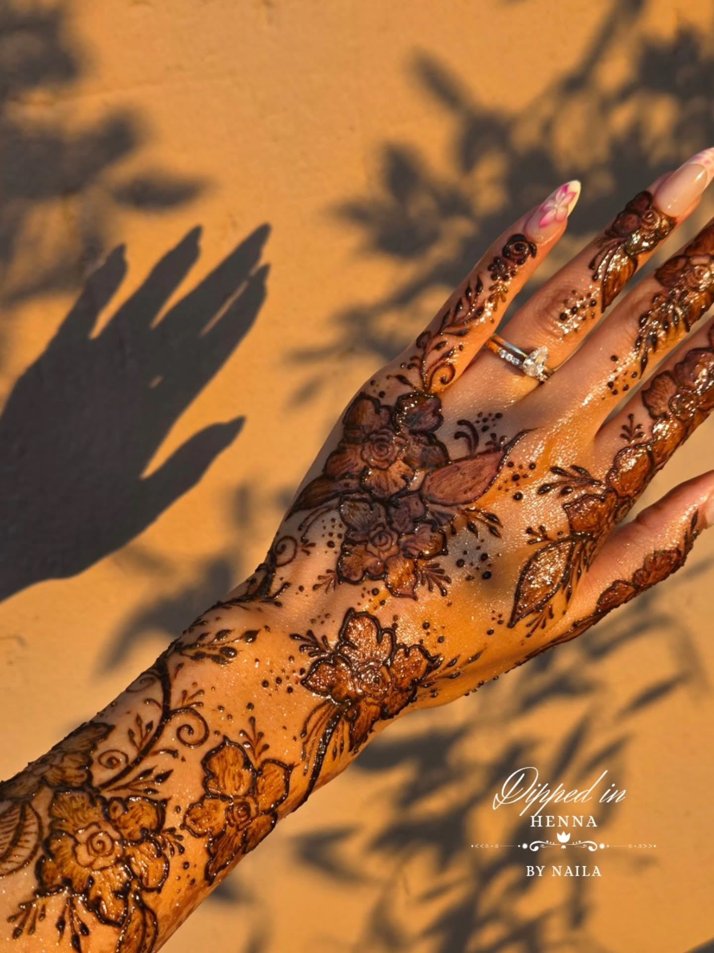 Detailed henna on the hand with leaf shadows