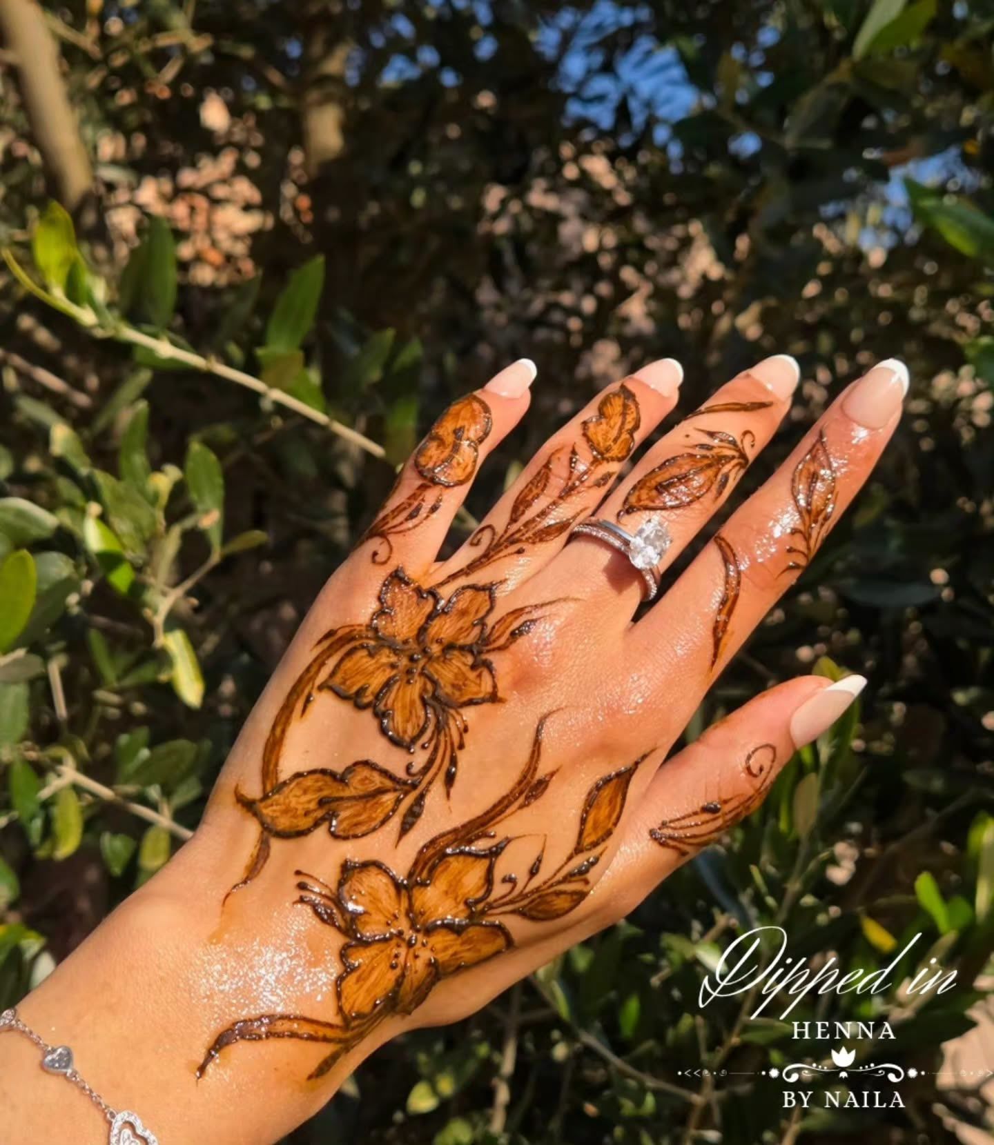 Floral henna with leaves and a ring, among branches