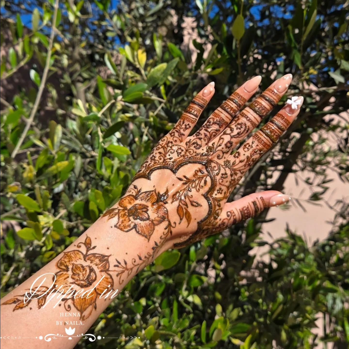 Above-the-wrist henna: florals running from the hand past the wrist