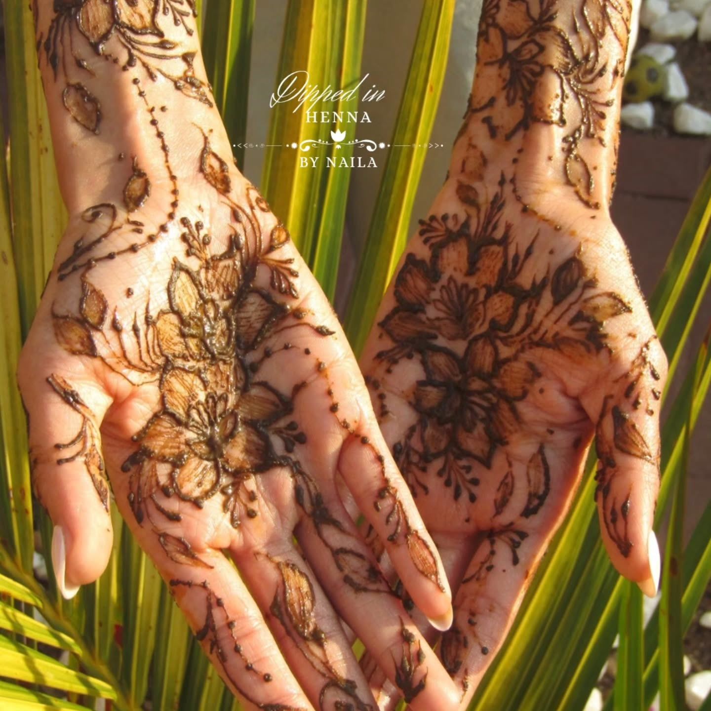 Two palms with matching detailed henna